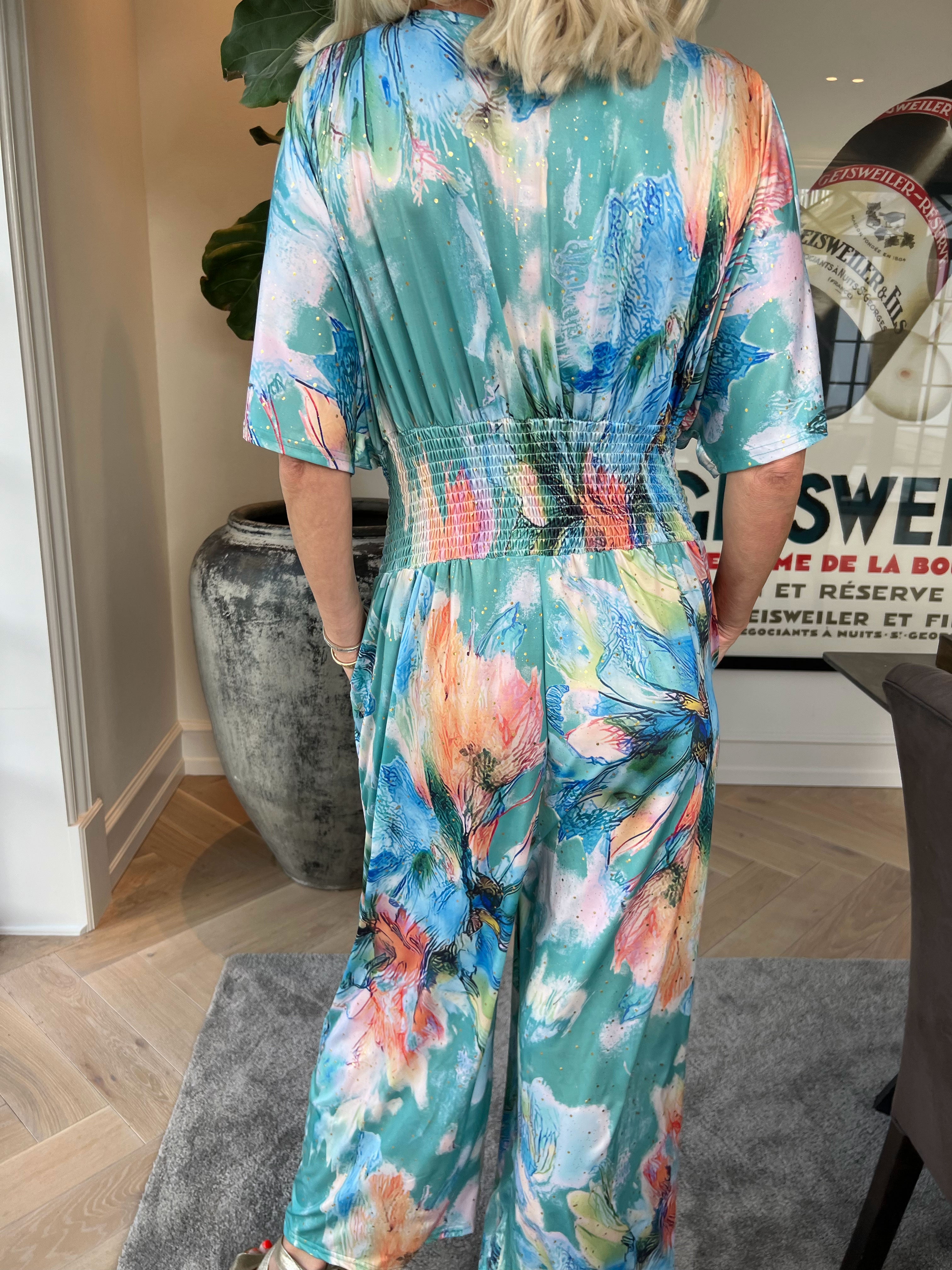 Pams Print Jumpsuit - Stretchig mönstrad jumpsuit med guldfärgat damm