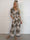 Pams Artsy Jumpsuit - Elastisk mønstret buksedragt med guld dutter