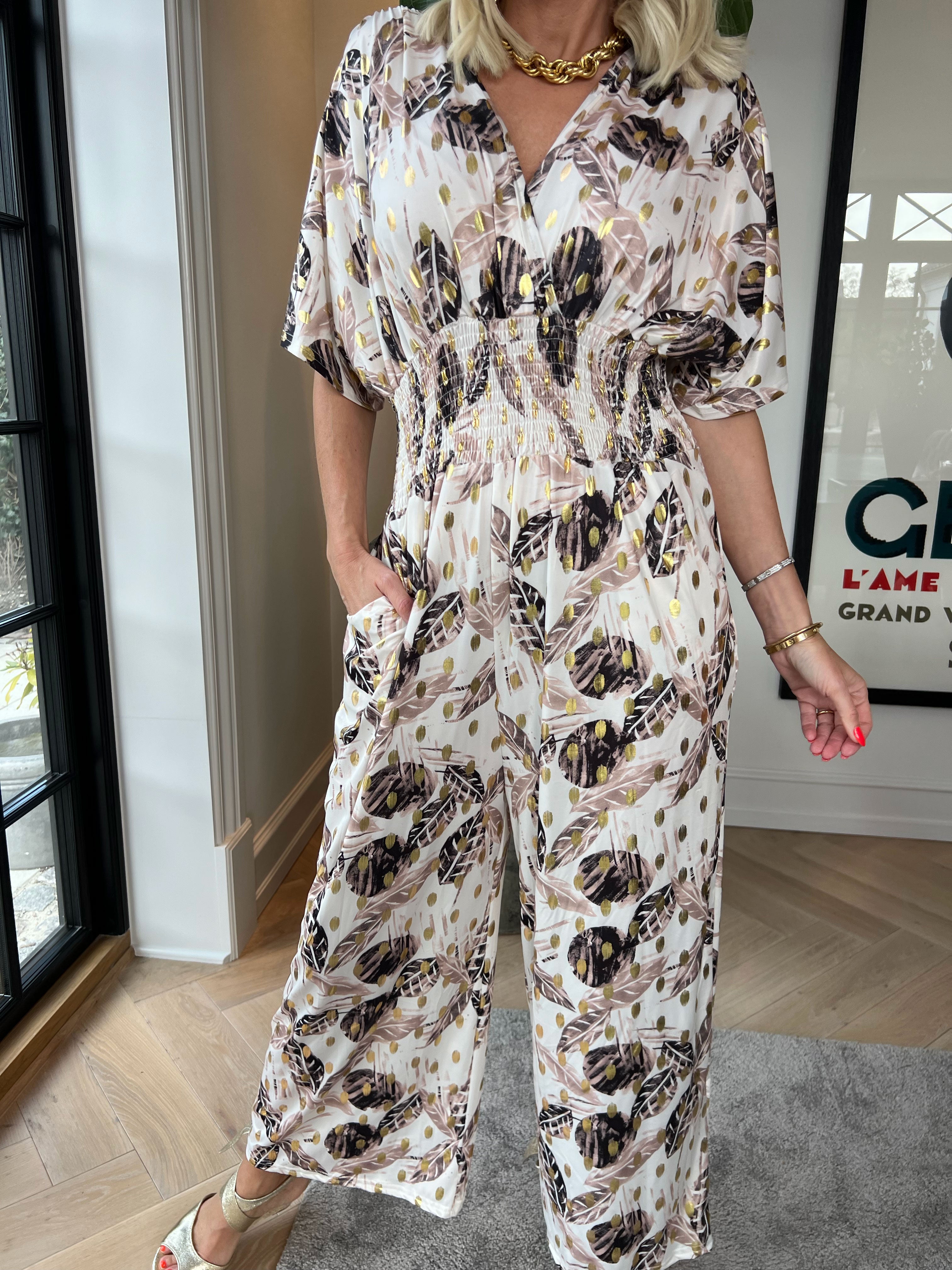 Pams Leafage Jumpsuit - Elastisk jumpsuit i lövmönster med guldfärgade tofsar