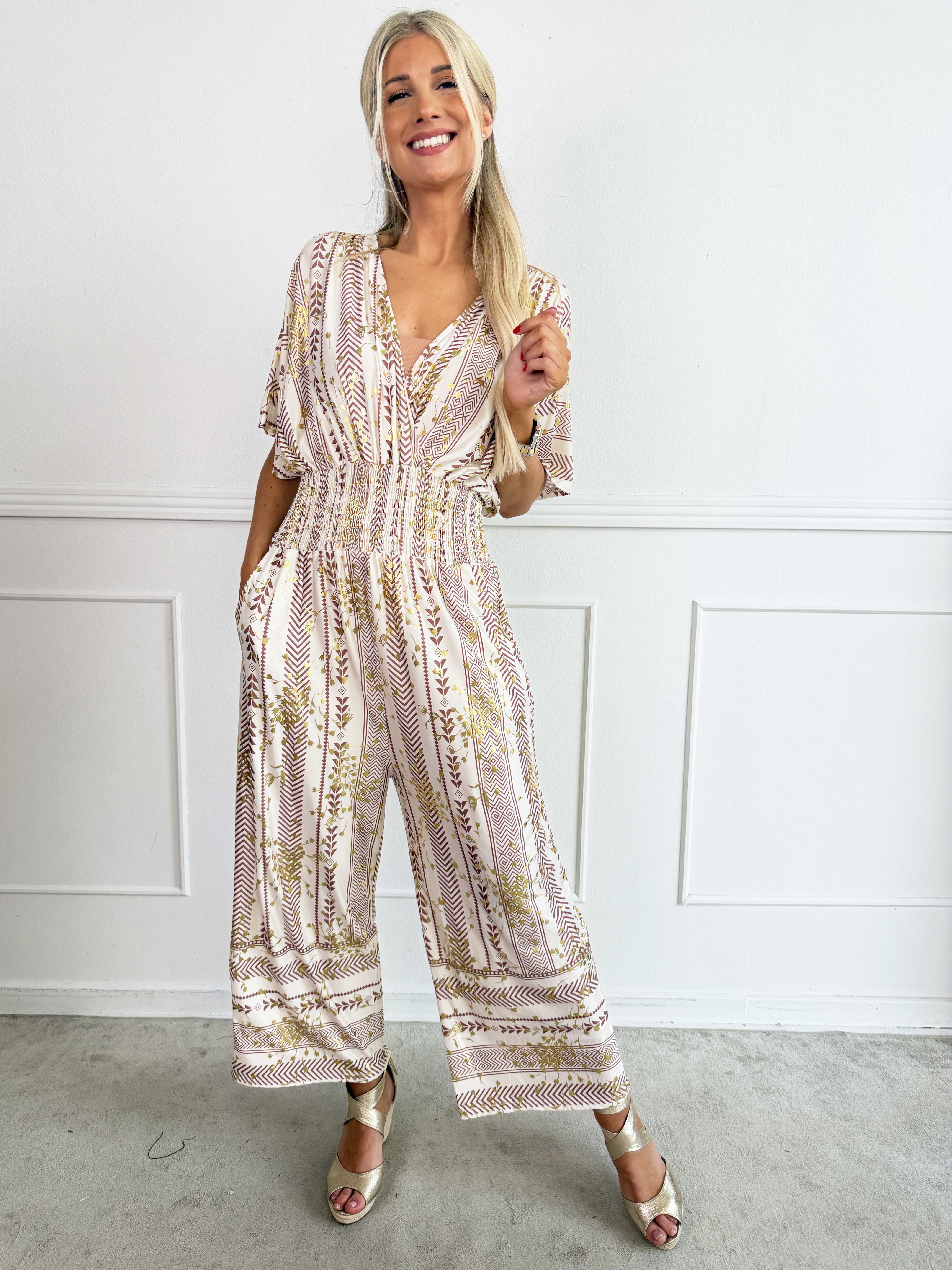 Pams Tribal Jumpsuit - Elastisk mønstret buksedragt med små guld blomster