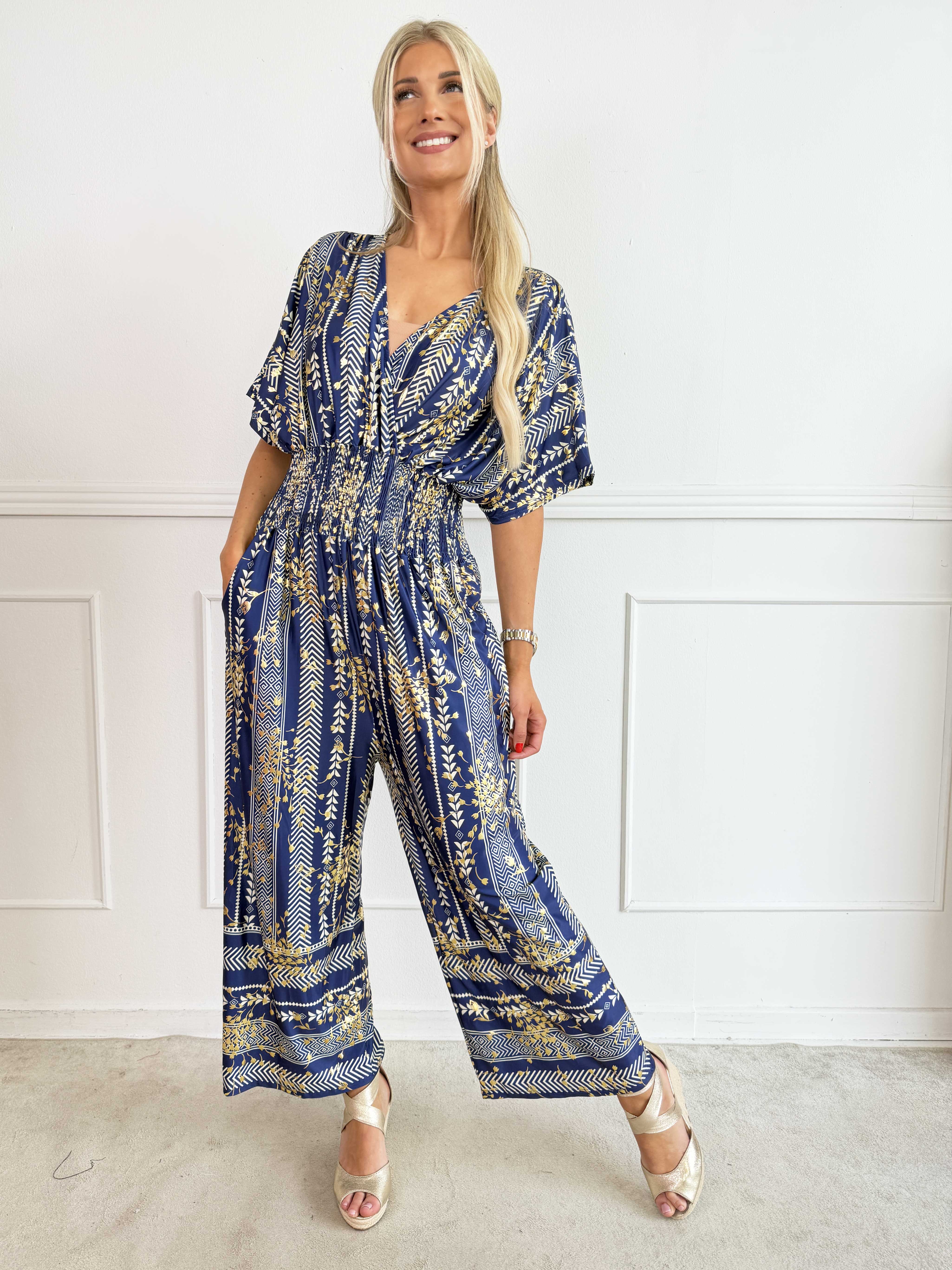 Pams Tribal Jumpsuit - Elastisk mønstret buksedragt med små guld blomster