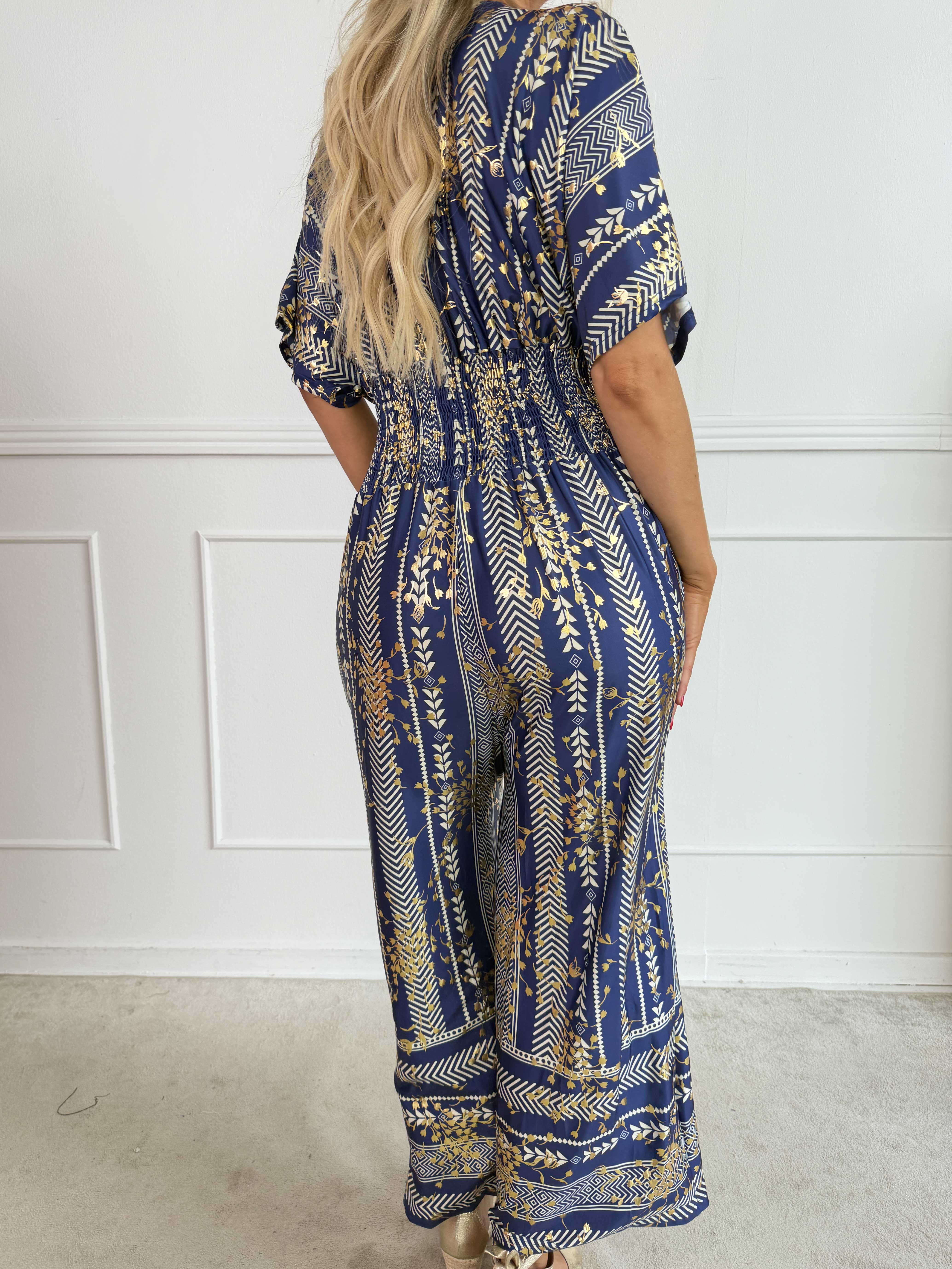 Pams Tribal Jumpsuit - Elastisk mønstret buksedragt med små guld blomster